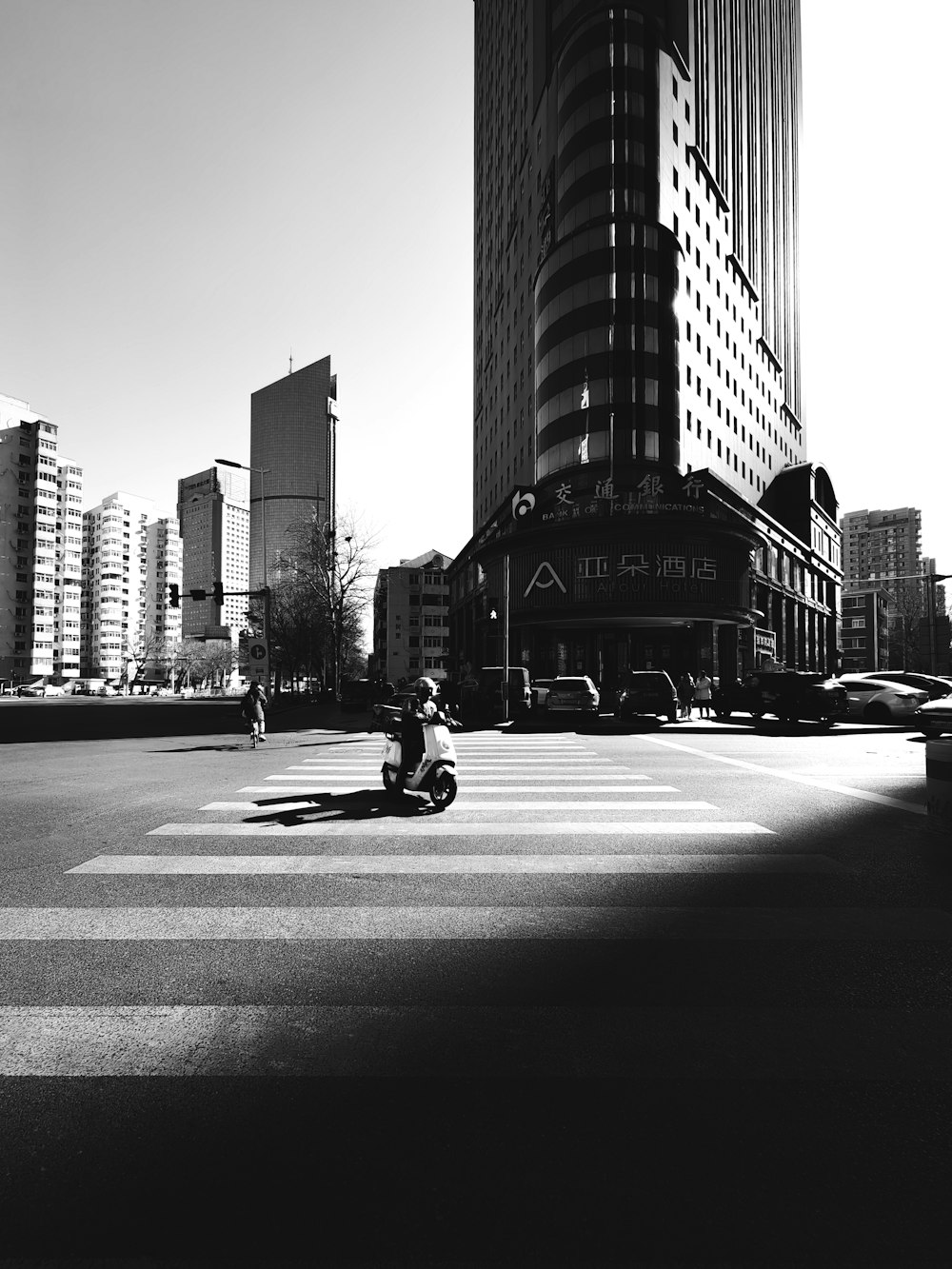 a person riding a motorcycle in a city