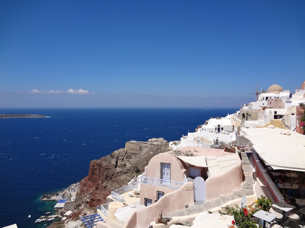 a group of buildings on a cliff by the ocean