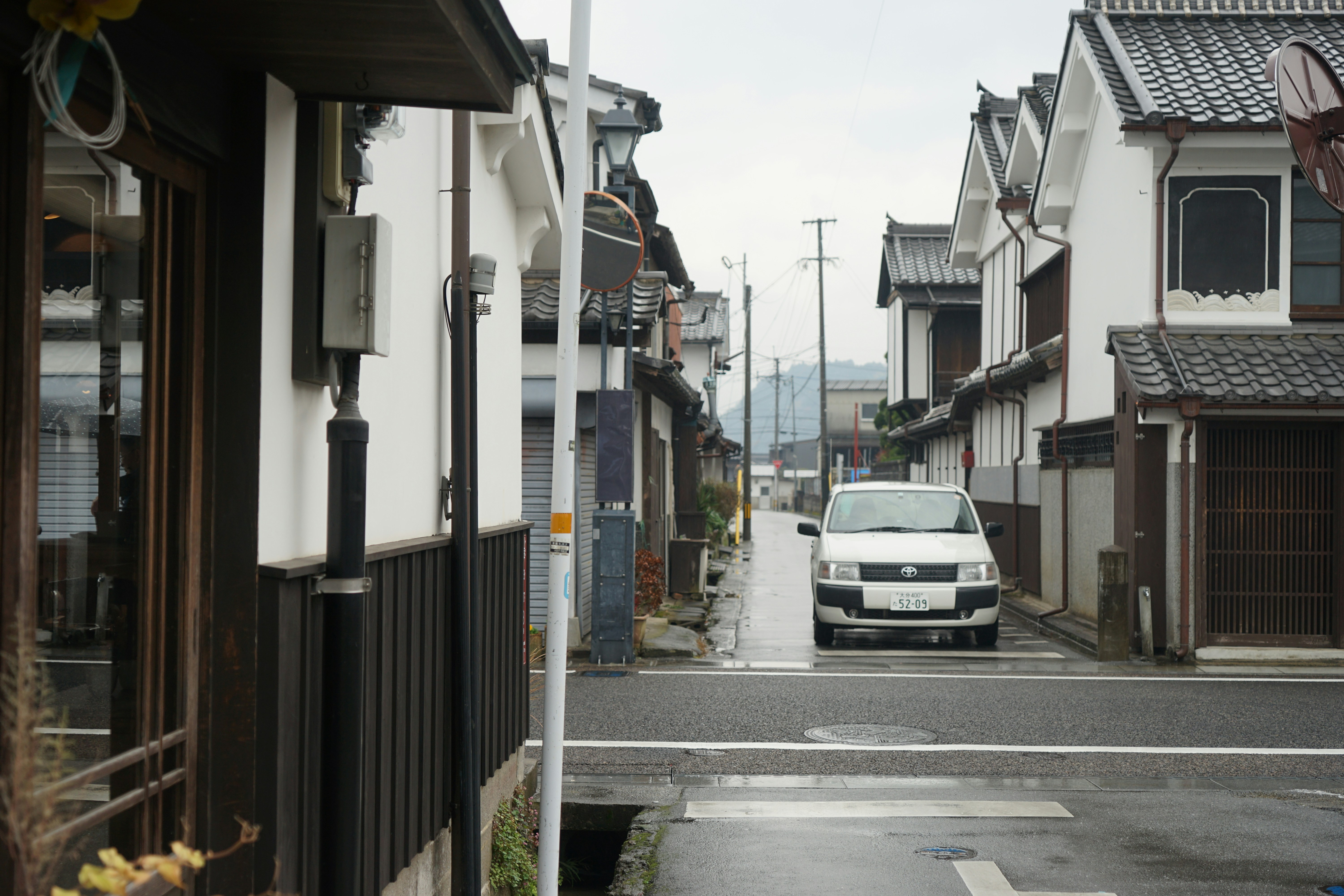 a white car parked on the side of a street