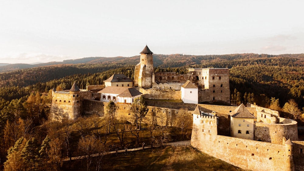 a large building with a tower and a castle on a hill