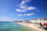 a beach with buildings along it