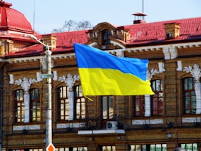 a flag flying in front of a building