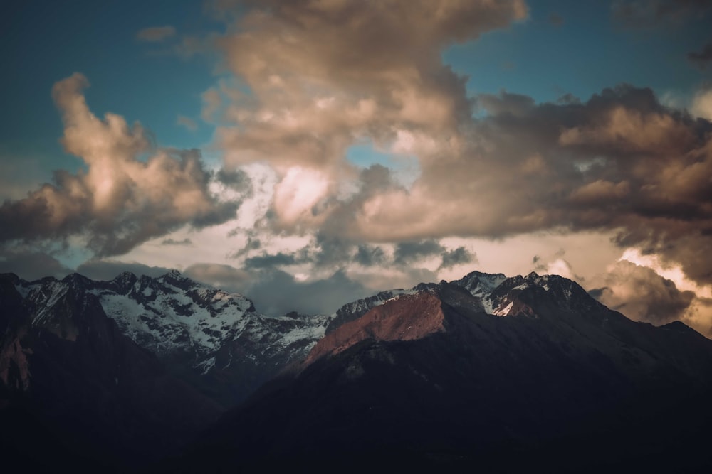 a mountain range with clouds