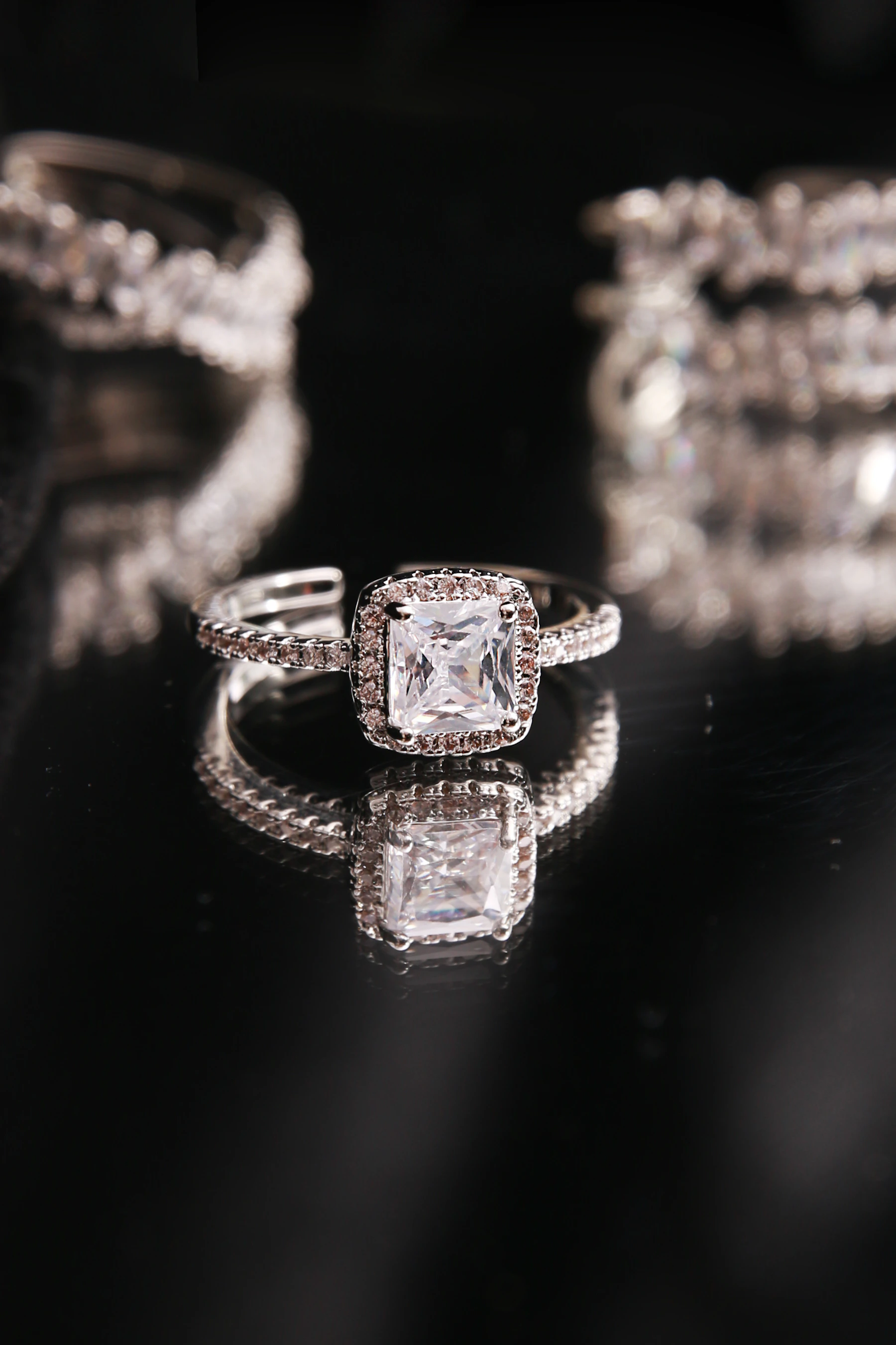 Diamond ring on a dark reflective surface