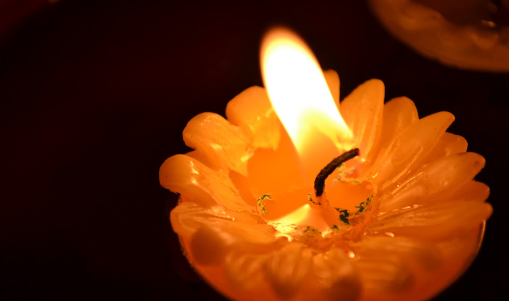 a candle burning in a flower