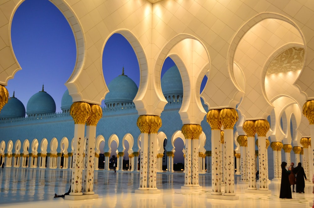 a large building with domed roofs with Sheikh Zayed Mosque in the background