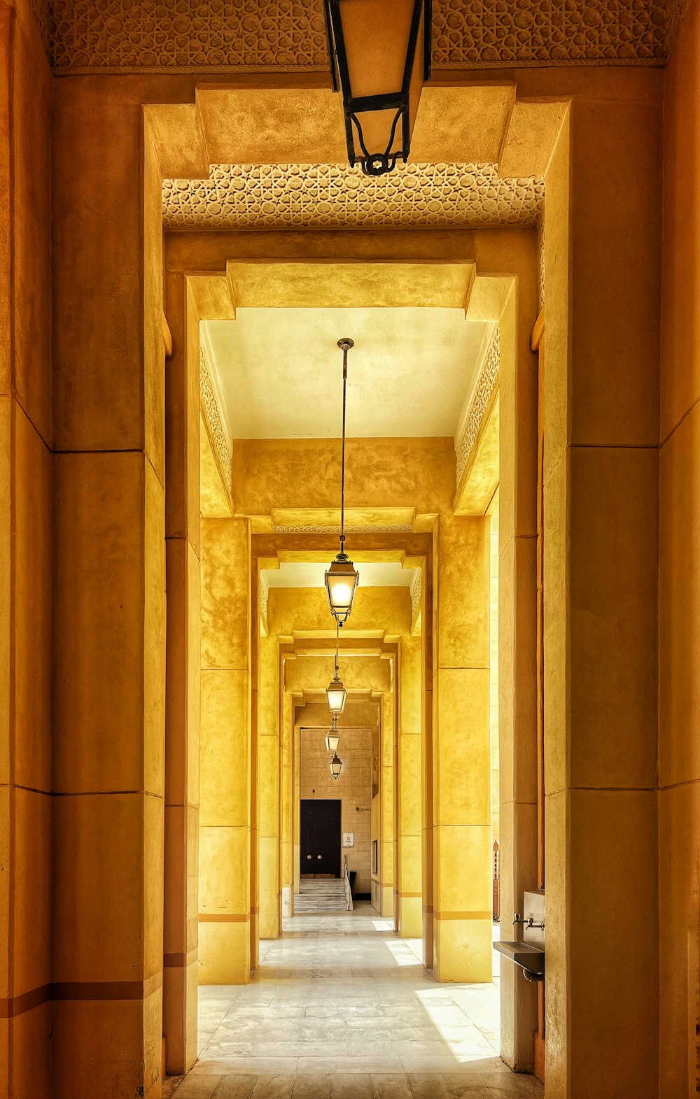 a hallway with a door and a light from the ceiling