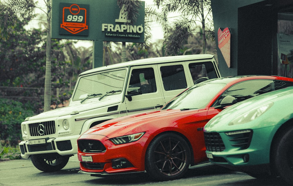 a couple of cars parked next to each other with signs in the back