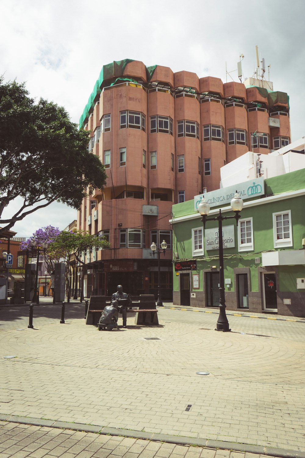 a person riding a scooter on a street in front of a large building