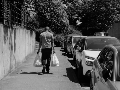 a man walking down a sidewalk