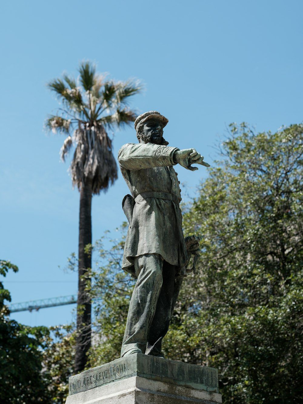 a statue of a person holding a tree