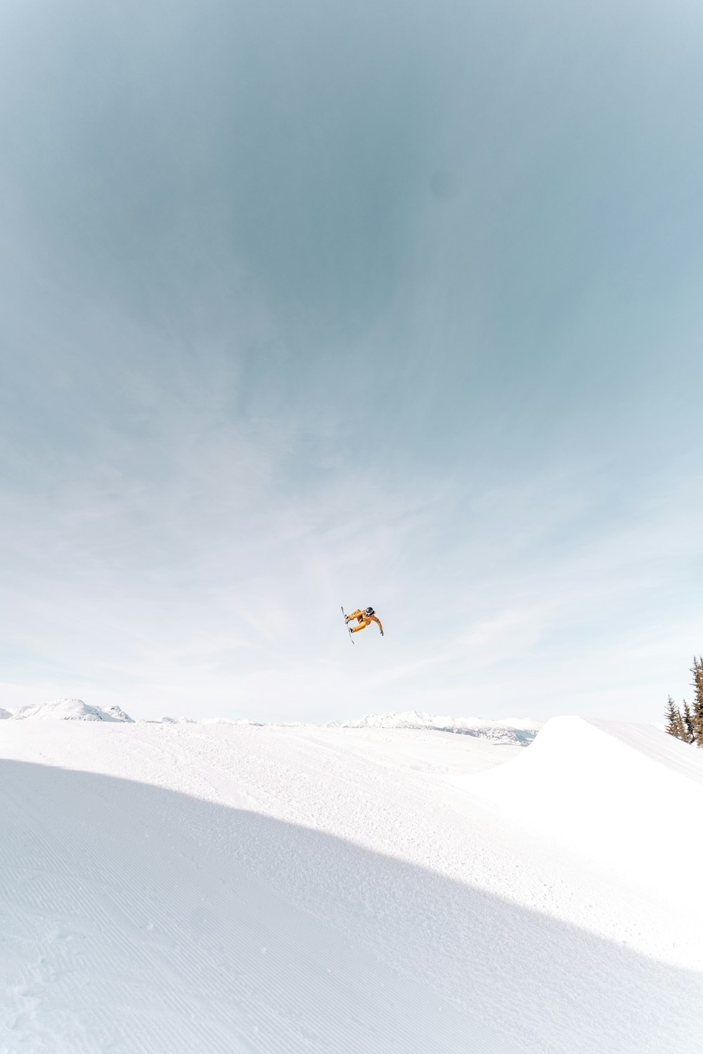 a person flying a kite in the snow