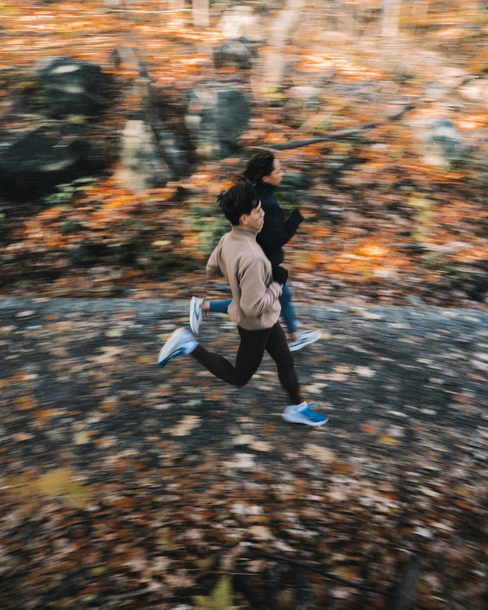 a couple of people playing frisbee in a park