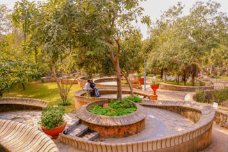 A peaceful garden area where residents enjoy fresh air and friendly conversation on benches.