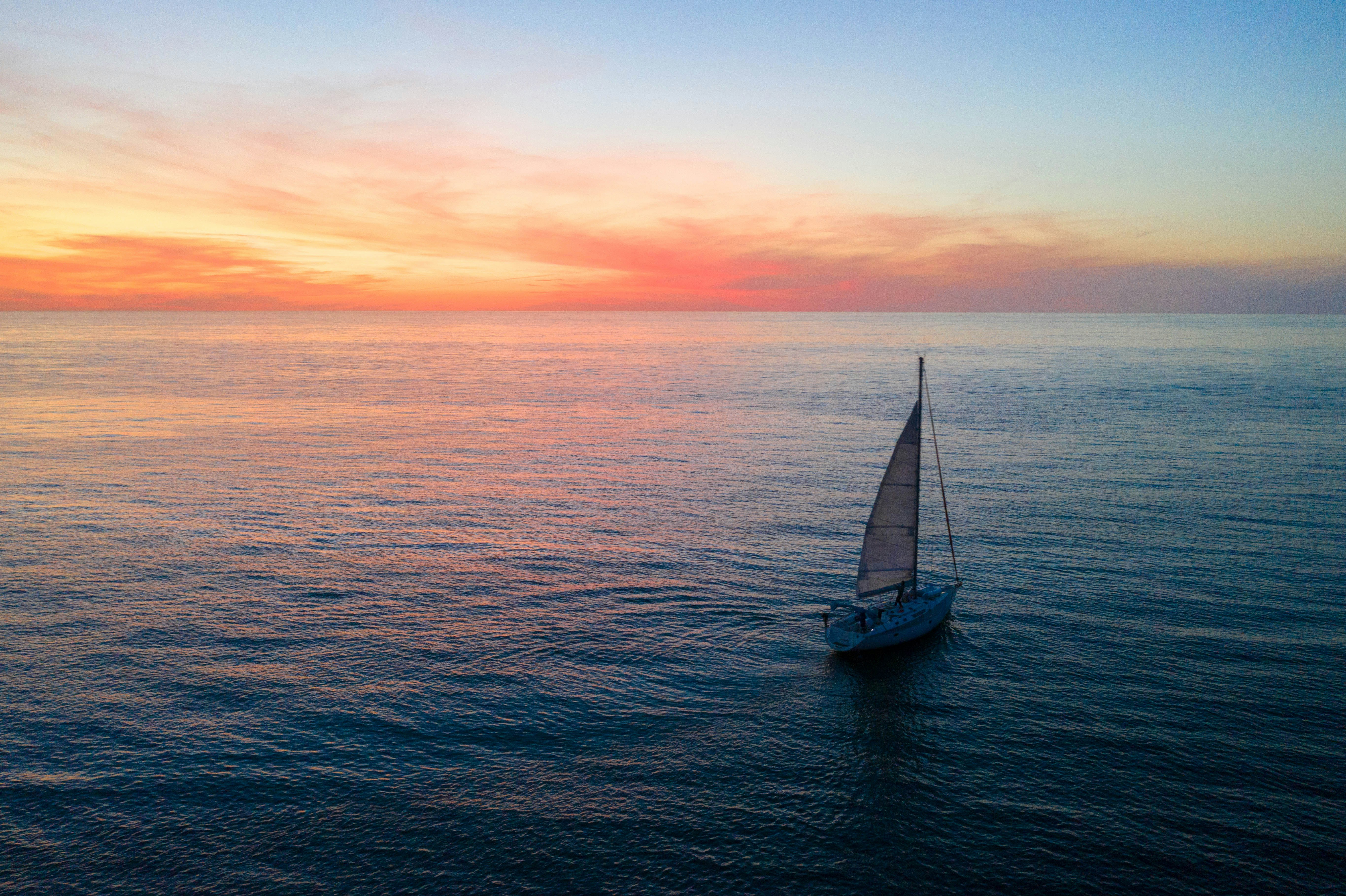a sailboat in the middle of the ocean