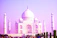 A vibrant photo of the Taj Mahal at sunrise with soft golden light illuminating the marble.