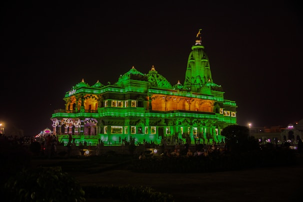 Evening view of the Tirupati temple lit up with traditional lamps, creating a warm, inviting glow.