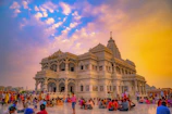 A vibrant photo of pilgrims at Kashi Vishwanath Temple during sunset.