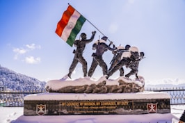 a statue of a group of men holding a flag