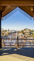 A vibrant outdoor scene showcasing a completed construction project with people enjoying the space.