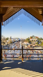 A vibrant community event at Patio Splendid with people engaging in art and conversation outdoors.