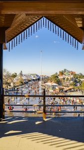A vibrant community gathering in a sunny Mexican plaza, smiling faces sharing stories.