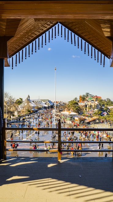 An outdoor convention center plaza showing naturally animated crowds walking and networking under sunny skies.