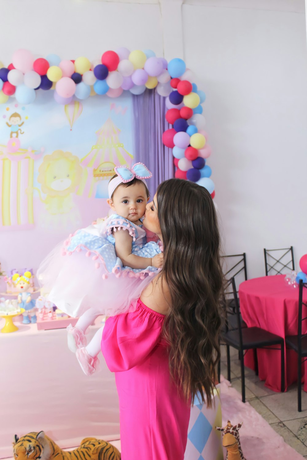 a person kissing a baby