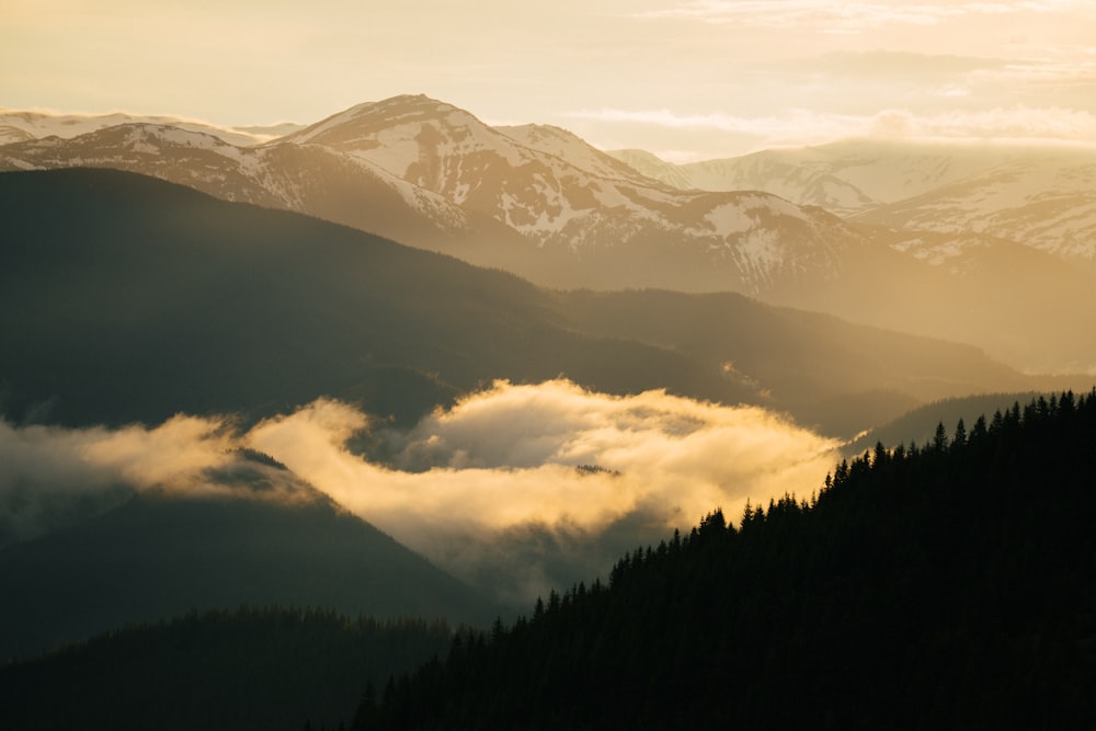 a mountain with clouds below