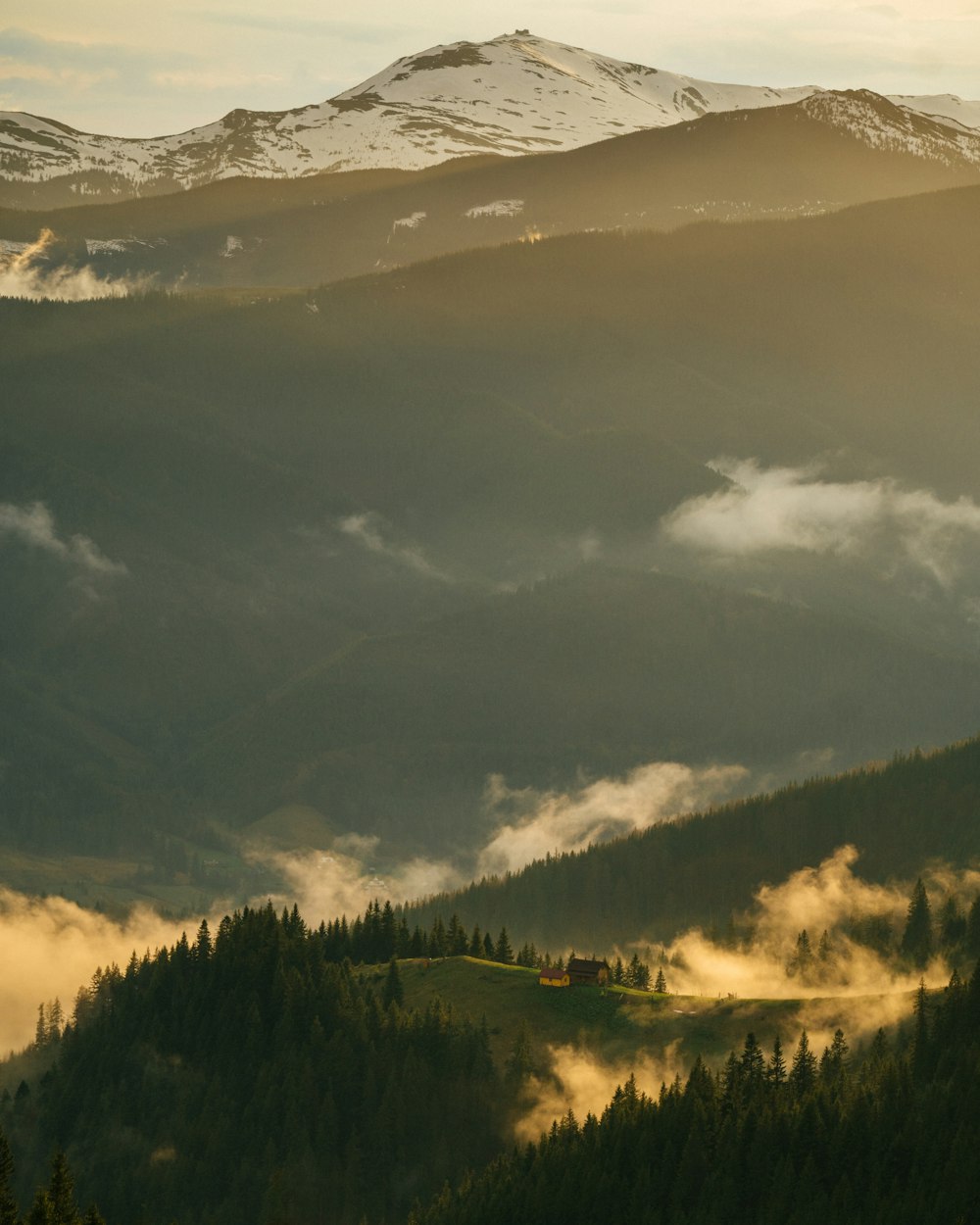 a mountain with clouds below