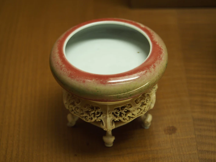 Close-up of a vibrant hand-carved marble bowl with intricate floral patterns in warm hues