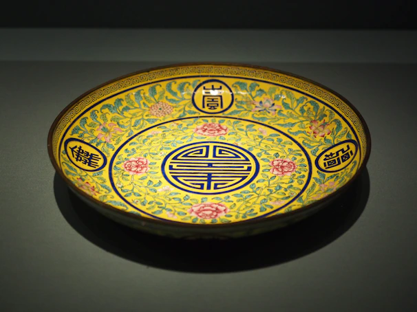 Hand-painted decorative plate with vibrant floral designs