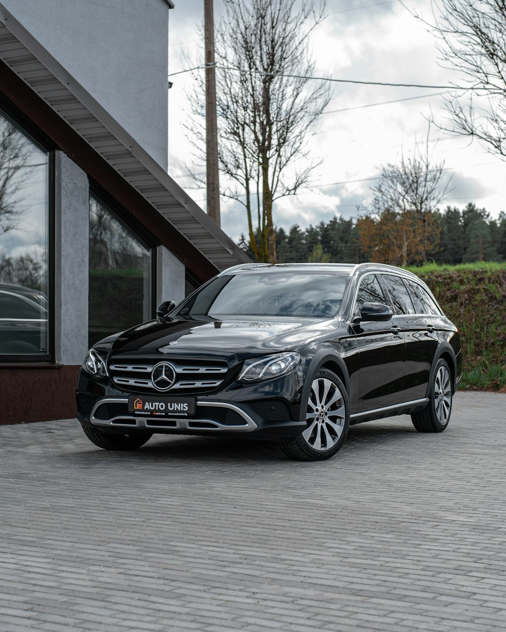 a black car parked outside a building