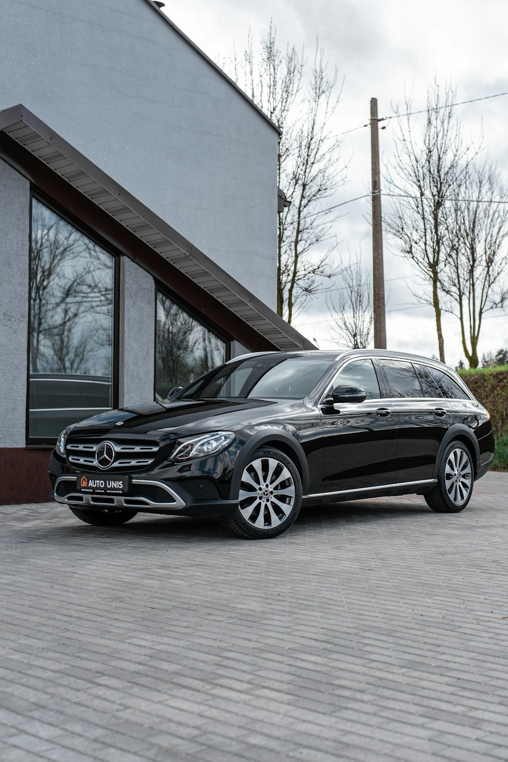 a black car parked outside a building