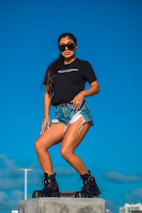 A confident woman posing in trendy casual wear outdoors.