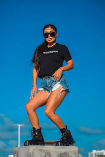 A model walking confidently in classic cowboy boots against a sunset backdrop.