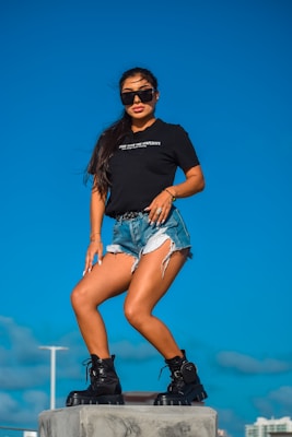 A confident woman posing in trendy casual wear outdoors.