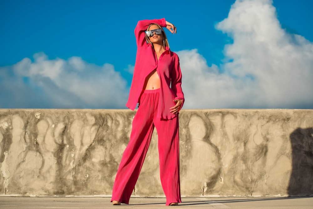 a person wearing a pink suit and sunglasses