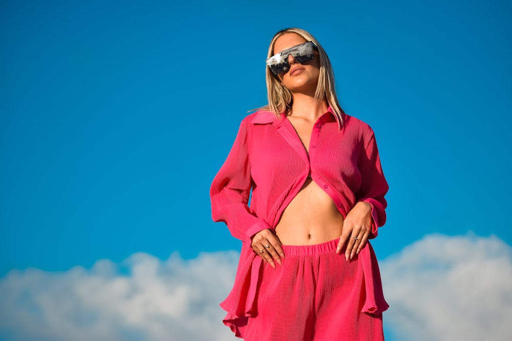 a woman wearing a pink suit