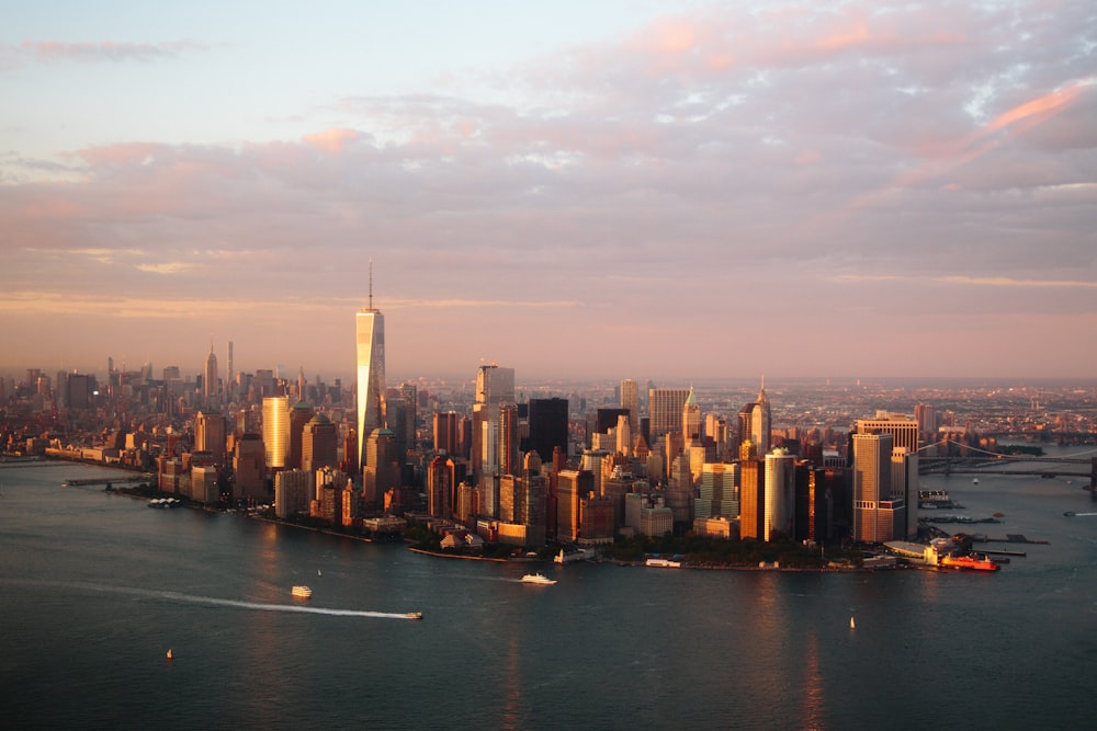 a city skyline with a body of water in the foreground