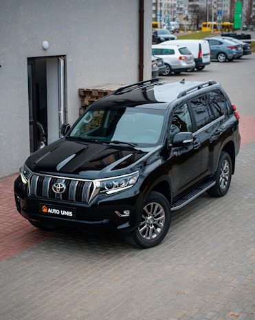 A secure transportation vehicle parked outside a corporate building.