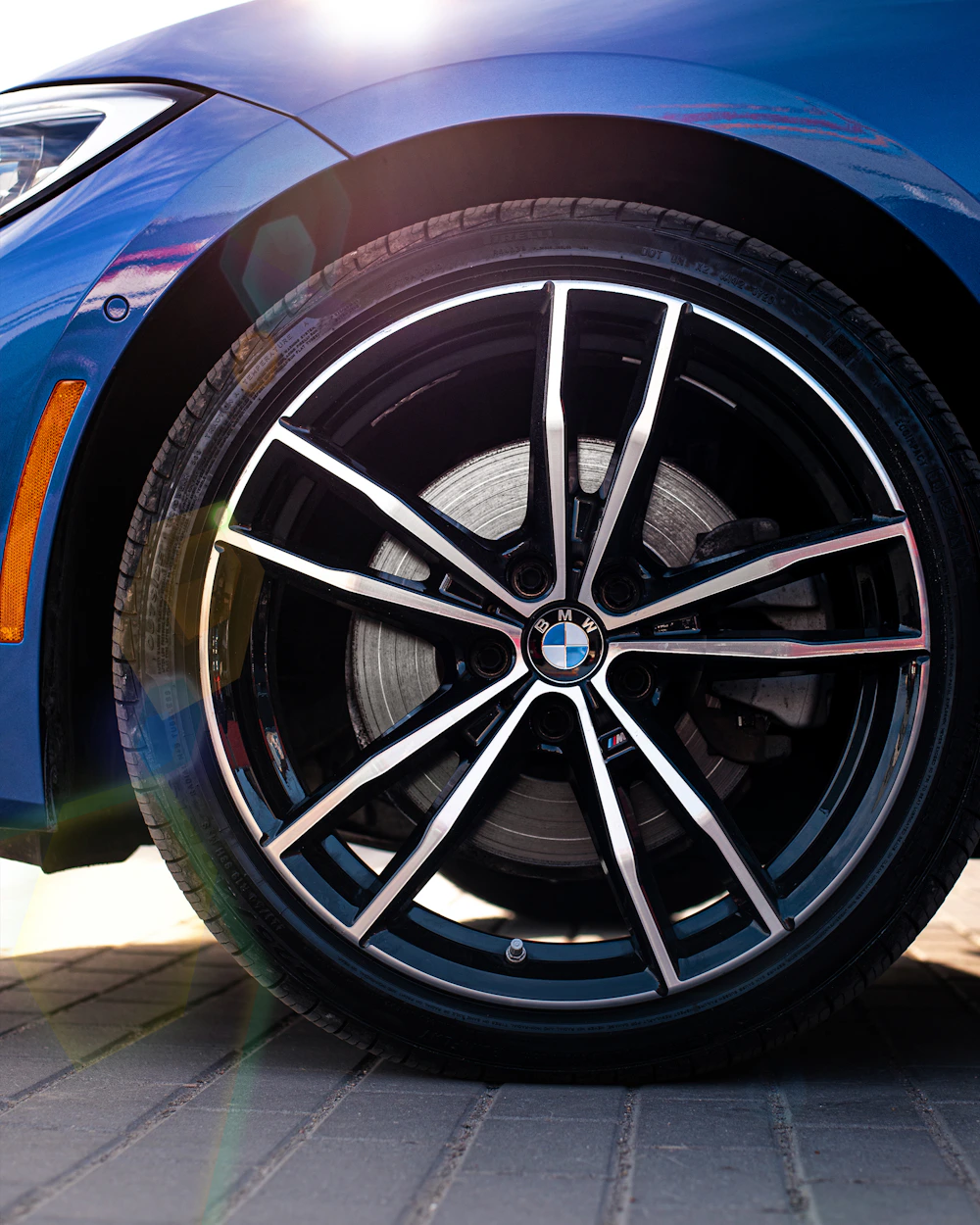 Close-up of a blue BMW with its wheel and tyre