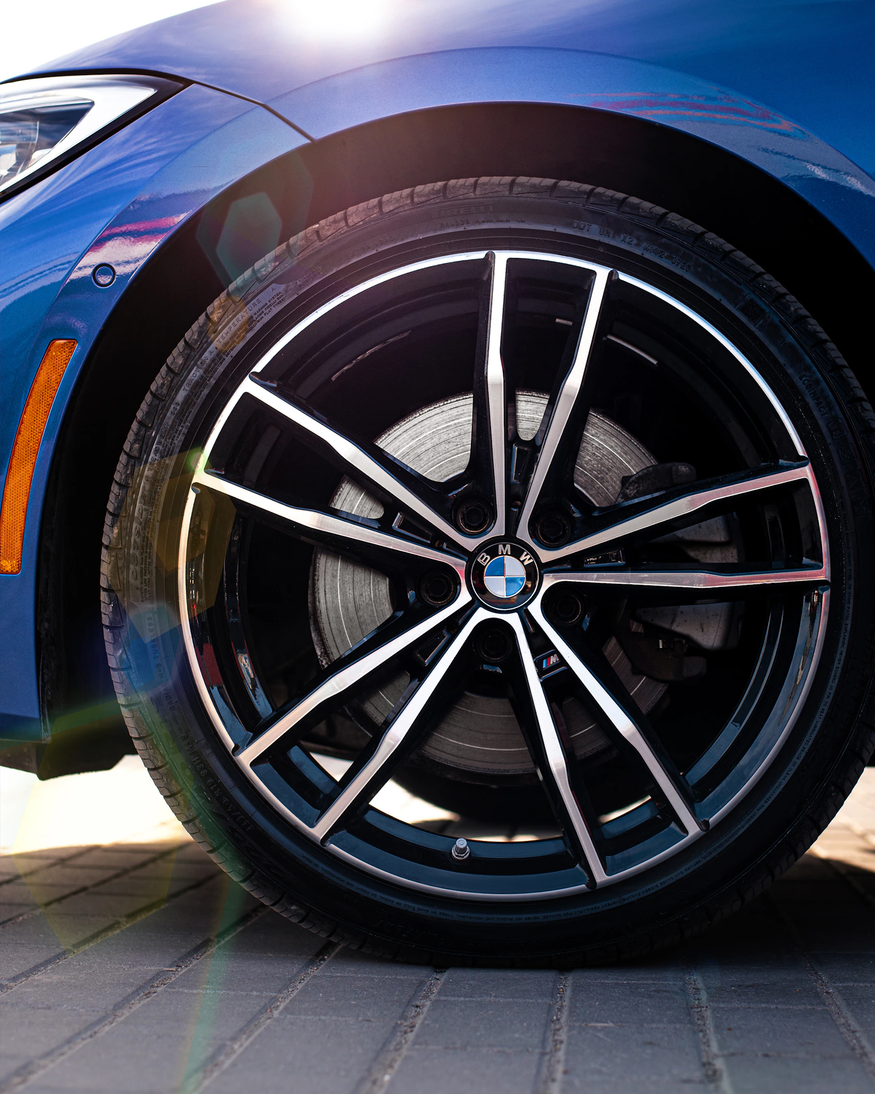 Close-up of a blue BMW with its wheel and tyre