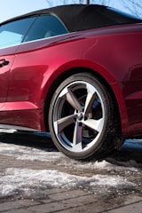 a car with a dent in the front wheel