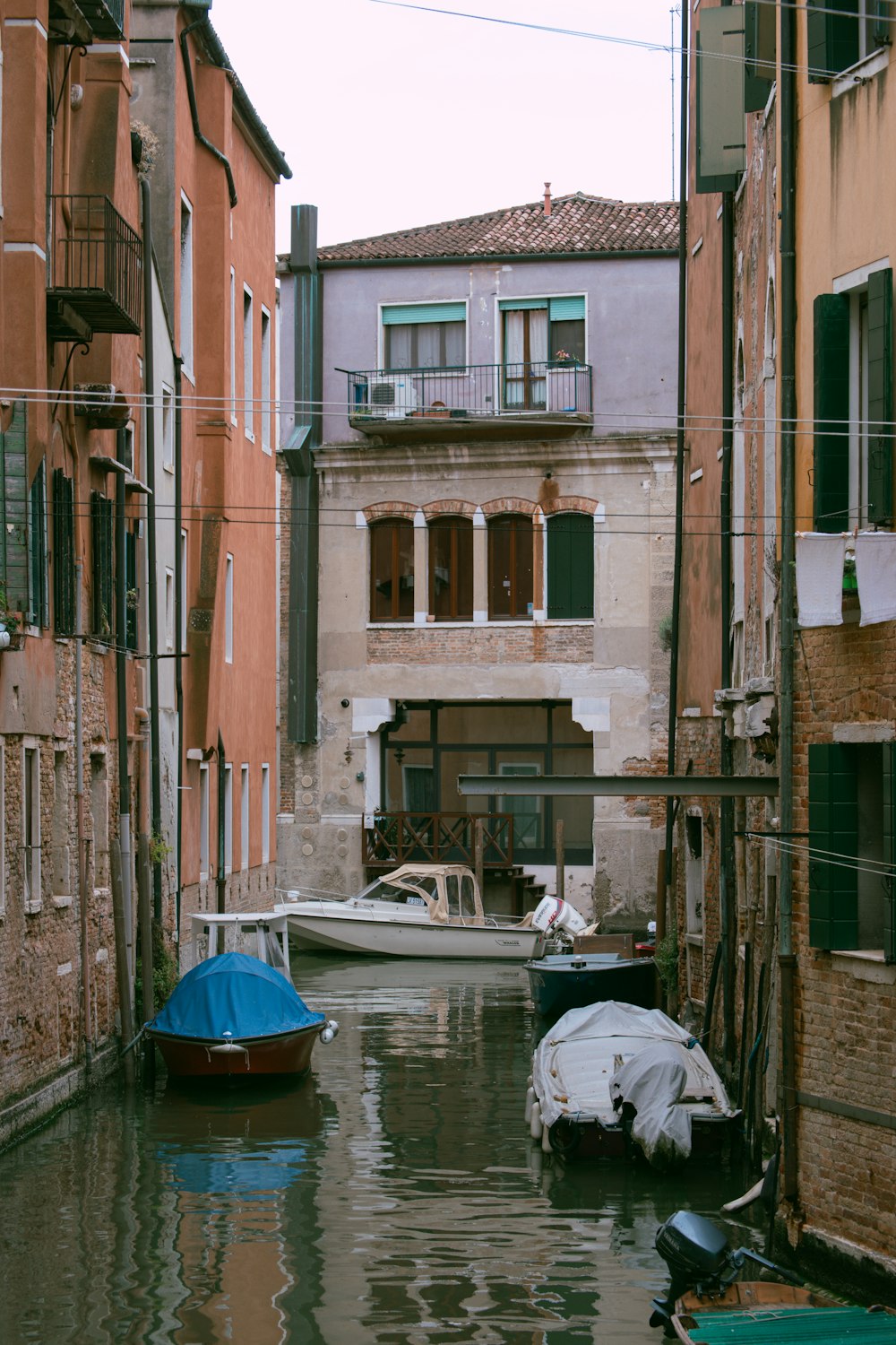 a canal with boats and buildings