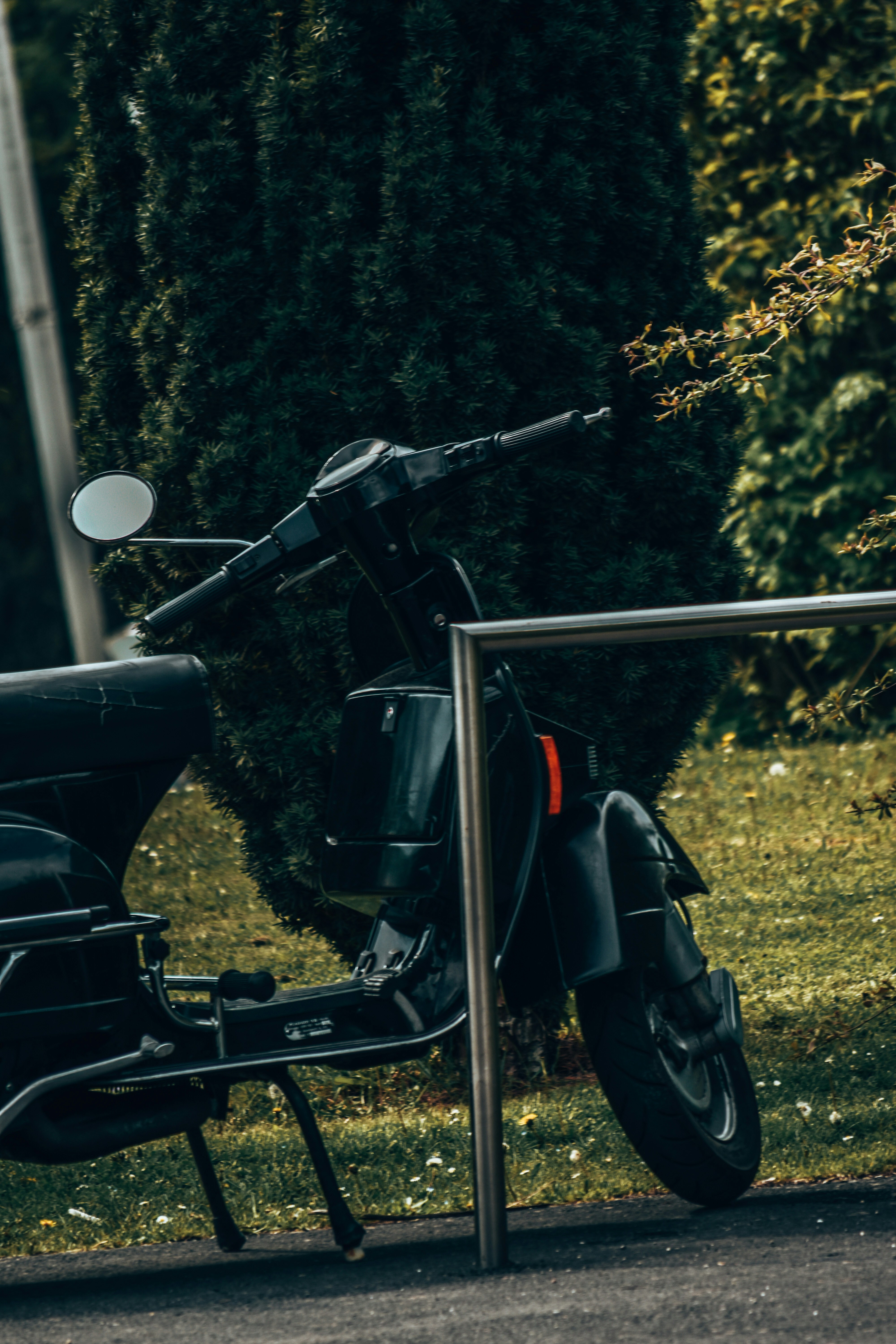 a black motorcycle parked on a sidewalk