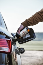 a person holding a bottle of alcohol