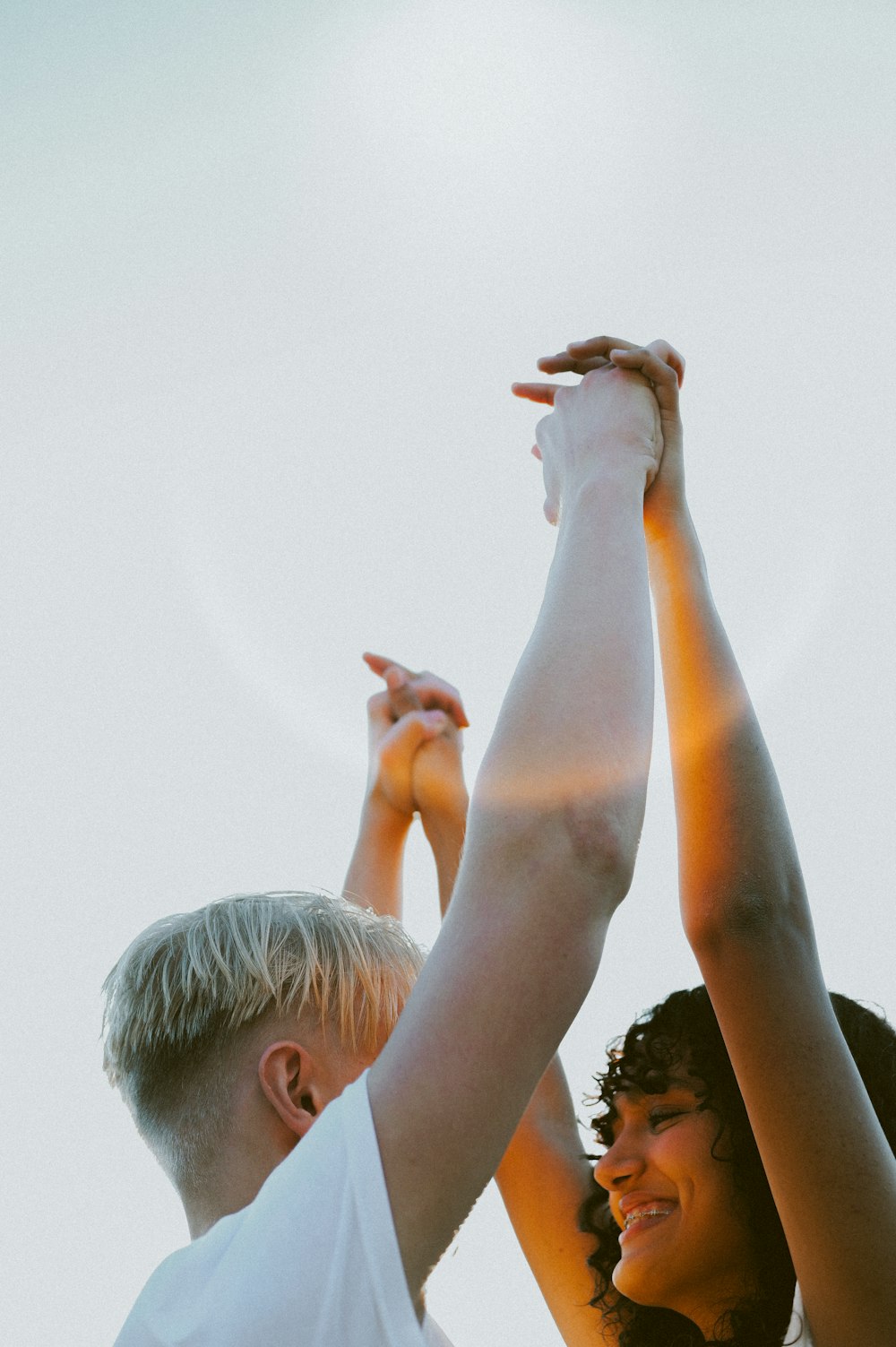 a man and a woman holding up their hands