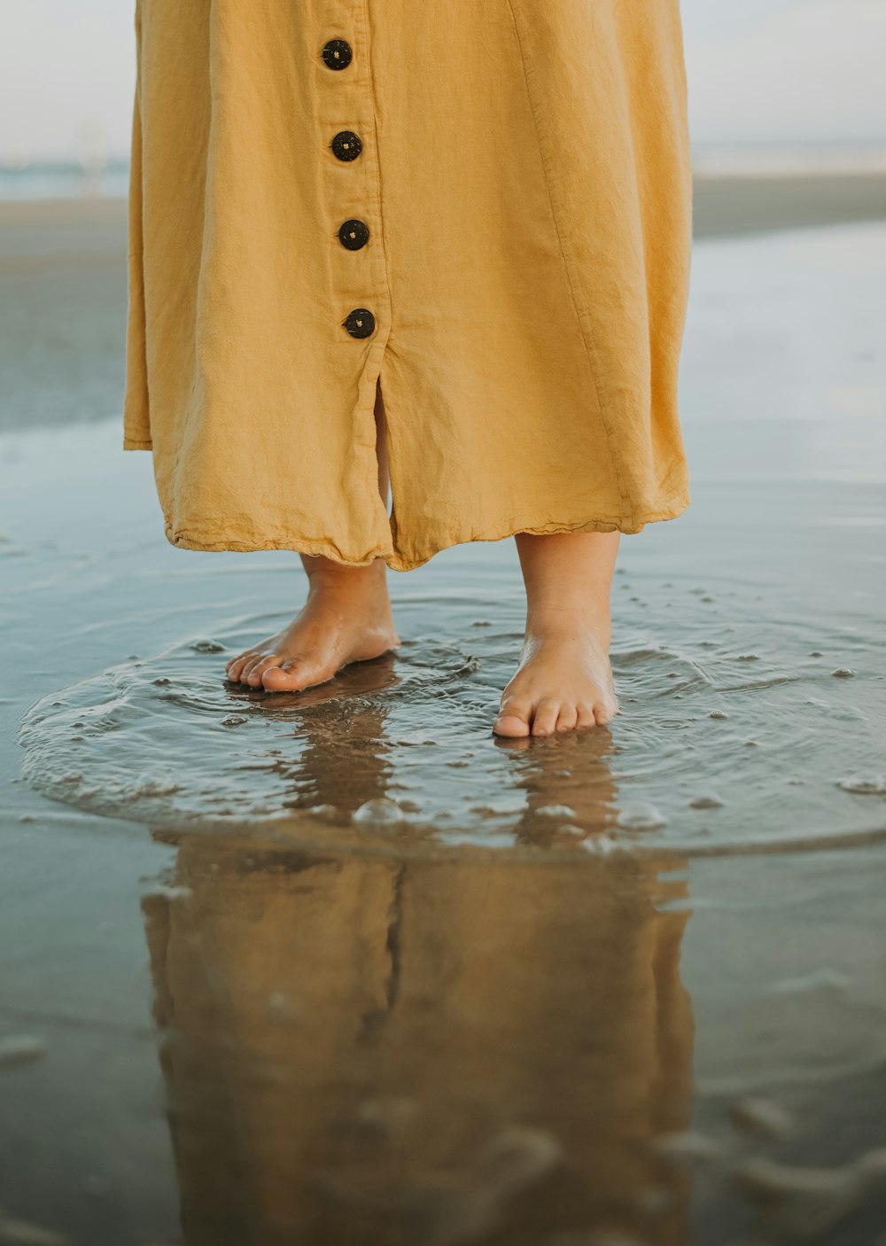 a person's legs in a yellow dress