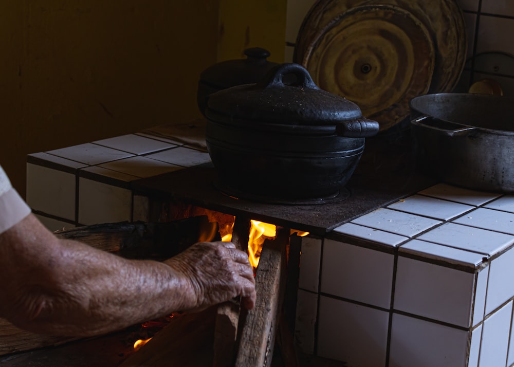 a person putting a fire in a stove